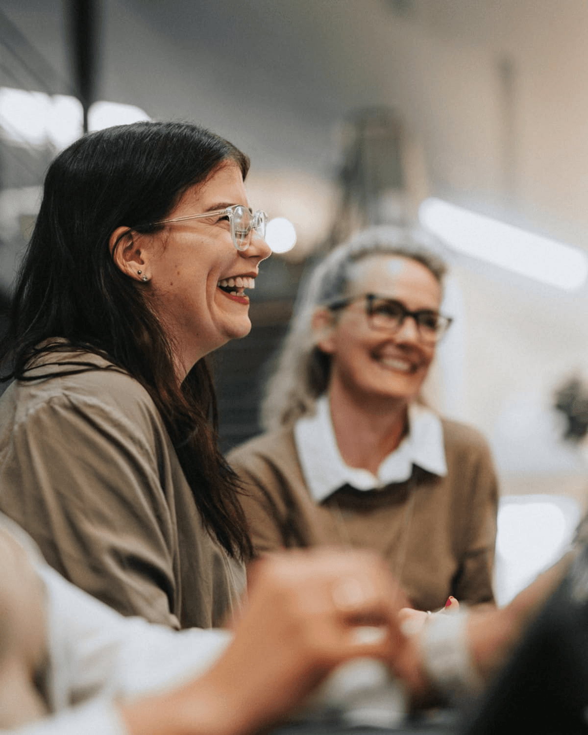 Two colleagues sharing a laugh at work